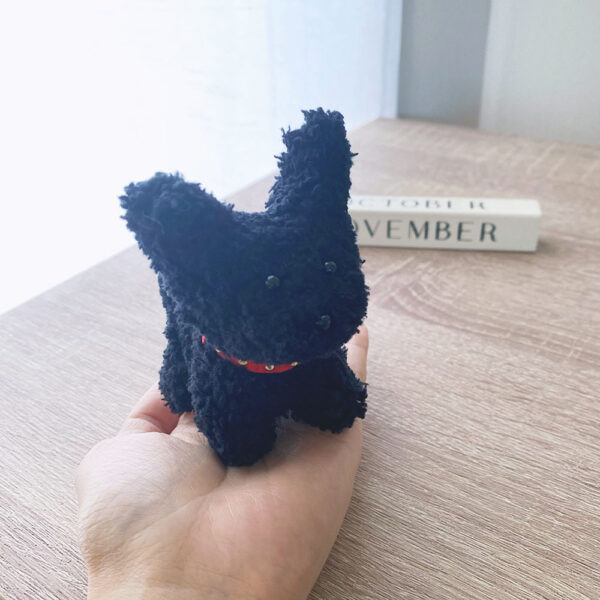 A Black Puppy with Pointy Ears